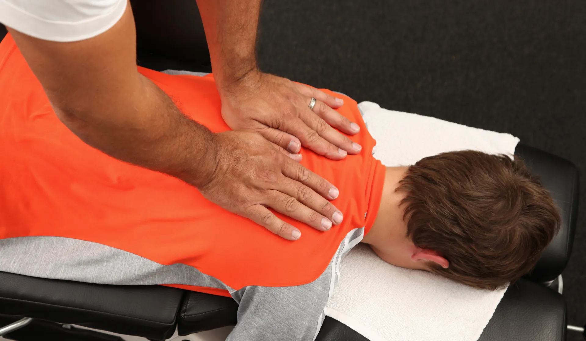 Chiropractor smiling while reviewing digital marketing analytics on tablet